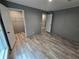 A bedroom with wood-look flooring, closet, and neutral paint throughout at 3174 Sw 189Th Ave, Dunnellon, FL 34432
