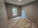Empty bedroom with wood-look flooring, a window, and neutral gray walls at 3174 Sw 189Th Ave, Dunnellon, FL 34432