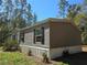 Charming single story home featuring neutral siding, black shutters, manicured landscaping at 3174 Sw 189Th Ave, Dunnellon, FL 34432