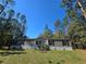 Charming single story home featuring gray siding, black shutters and a well-maintained lawn at 3174 Sw 189Th Ave, Dunnellon, FL 34432