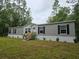 Home exterior with gray siding and dark shutters at 3174 Sw 189Th Ave, Dunnellon, FL 34432