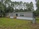 Back of home exterior with stairs leading to the backyard at 3174 Sw 189Th Ave, Dunnellon, FL 34432