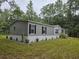 Home exterior with gray siding and dark shutters at 3174 Sw 189Th Ave, Dunnellon, FL 34432