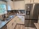 Kitchen featuring a stainless steel refrigerator, double sink, and ample cabinet space at 3174 Sw 189Th Ave, Dunnellon, FL 34432