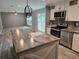 Kitchen featuring an island with marble countertops, a stainless-steel dishwasher, and a microwave at 3174 Sw 189Th Ave, Dunnellon, FL 34432