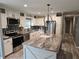 Kitchen with an island that has marble countertops, a stainless-steel refrigerator, and a sink at 3174 Sw 189Th Ave, Dunnellon, FL 34432