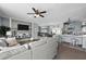 Open living room features a ceiling fan, gray walls, and an entertainment center at 3174 Sw 189Th Ave, Dunnellon, FL 34432