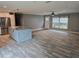 The kitchen has an island that connects to the living room with large windows and a ceiling fan at 3174 Sw 189Th Ave, Dunnellon, FL 34432