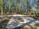 Concrete parking pad on a long wooded driveway at 3174 Sw 189Th Ave, Dunnellon, FL 34432
