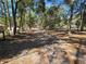 Scenic view of wooded property with a long dirt driveway leading to the residences at 3174 Sw 189Th Ave, Dunnellon, FL 34432