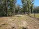 Gated property entrance with trees lining the driveway at 3174 Sw 189Th Ave, Dunnellon, FL 34432
