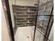 The shower features dark faux-wood tiling, glass enclosure, and updated shower head at 3174 Sw 189Th Ave, Dunnellon, FL 34432