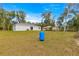 Spacious backyard featuring lush greenery, and the rear exterior of the house at 4048 Se 134Th St, Belleview, FL 34420