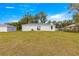 The backyard features an exterior view of the back of the house with a covered patio and landscaping at 4048 Se 134Th St, Belleview, FL 34420