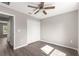 This bedroom features a ceiling fan, closet, and access to the hallway with wood-look vinyl flooring at 4048 Se 134Th St, Belleview, FL 34420