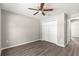 Cozy bedroom featuring a ceiling fan, closet, and durable wood-look vinyl floors at 4048 Se 134Th St, Belleview, FL 34420