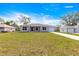 Charming single-story home featuring a well-maintained lawn, gray exterior, and attached one car garage at 4048 Se 134Th St, Belleview, FL 34420