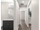 Hallway view of the bathroom and kitchen; showcasing the layout and wood-look vinyl floors at 4048 Se 134Th St, Belleview, FL 34420
