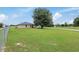 Backyard view of house with large tree and fence at 4660 Sw 130Th St, Ocala, FL 34473