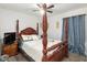 Bedroom with a wooden four-poster bed and carpet flooring at 4660 Sw 130Th St, Ocala, FL 34473