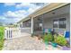 Brick paved patio with lush landscaping and white fence at 9124 Sw 84Th Ln, Ocala, FL 34481