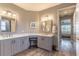 Elegant bathroom with dual vanities and a large mirror at 9124 Sw 84Th Ln, Ocala, FL 34481