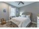 Bright bedroom with a queen-size bed and ceiling fan at 9124 Sw 84Th Ln, Ocala, FL 34481