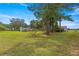 Large backyard with mature trees and a spacious lawn at 1000 Se 155Th St, Summerfield, FL 34491