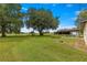 Spacious backyard with large trees, providing shade and privacy at 1000 Se 155Th St, Summerfield, FL 34491