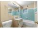 Bathroom with teal tile and vintage vanity at 1000 Se 155Th St, Summerfield, FL 34491