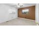 Bedroom with brown accent wall and ceiling fan at 1000 Se 155Th St, Summerfield, FL 34491