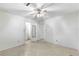 Large bedroom with ceiling fan and access to bathroom at 1000 Se 155Th St, Summerfield, FL 34491