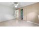 Spacious bedroom with ceiling fan and mirrored closet at 1000 Se 155Th St, Summerfield, FL 34491