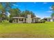 Single-story home with a large front yard and detached barn at 1000 Se 155Th St, Summerfield, FL 34491