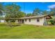 Ranch-style home with covered patio and expansive lawn at 1000 Se 155Th St, Summerfield, FL 34491