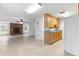 Kitchen with wood cabinets, and appliances. View of living room and backyard at 1000 Se 155Th St, Summerfield, FL 34491