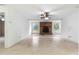 Spacious living room with brick fireplace and ceiling fan at 1000 Se 155Th St, Summerfield, FL 34491