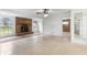 Living room with brick fireplace and terrazzo flooring at 1000 Se 155Th St, Summerfield, FL 34491