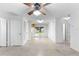 Living area with ceiling fan and access to kitchen and backyard at 1000 Se 155Th St, Summerfield, FL 34491