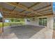 Covered patio with concrete flooring and picnic table at 1000 Se 155Th St, Summerfield, FL 34491