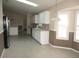 Kitchen with white cabinets, stainless steel appliances, and tile flooring at 11680 Sw 140Th Loop, Dunnellon, FL 34432