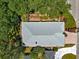 Aerial view of the home's roof surrounded by mature trees and lush landscaping at 17808 Se 115Th Ct, Summerfield, FL 34491