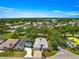 Aerial view of a home, showcasing the roof, driveway, landscaping, and surrounding neighborhood at 17808 Se 115Th Ct, Summerfield, FL 34491