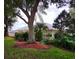 Backyard featuring mature trees, lush landscaping, and a well-maintained lawn at 17808 Se 115Th Ct, Summerfield, FL 34491