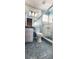 Blue tiled bathroom featuring a glass shower and a large mirror at 17808 Se 115Th Ct, Summerfield, FL 34491