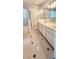 Well-lit bathroom featuring a glass shower and double sinks at 17808 Se 115Th Ct, Summerfield, FL 34491