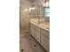Bright bathroom with glass enclosed shower, tile floors, and double sink vanity with great lighting at 17808 Se 115Th Ct, Summerfield, FL 34491