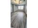 Bedroom with wood-look flooring, large window, and ceiling fan at 17808 Se 115Th Ct, Summerfield, FL 34491