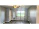 Neutral-colored bedroom with wood-look floors, ceiling fan, and natural light at 17808 Se 115Th Ct, Summerfield, FL 34491