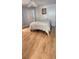 Inviting bedroom features hardwood floors, a comfortable bed, and a bright airy atmosphere at 17808 Se 115Th Ct, Summerfield, FL 34491
